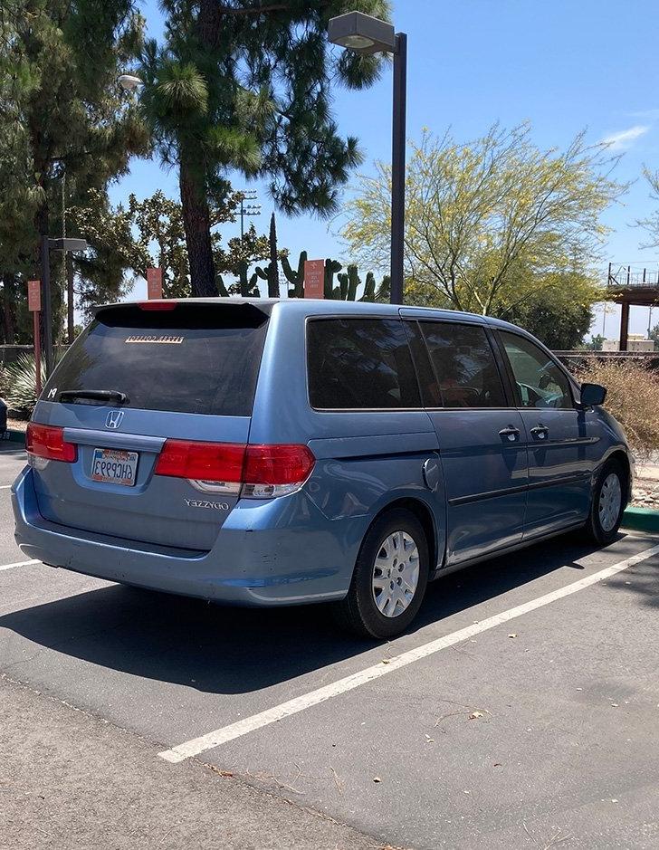 a blue pitzer minivan parked in east mesa parking lot